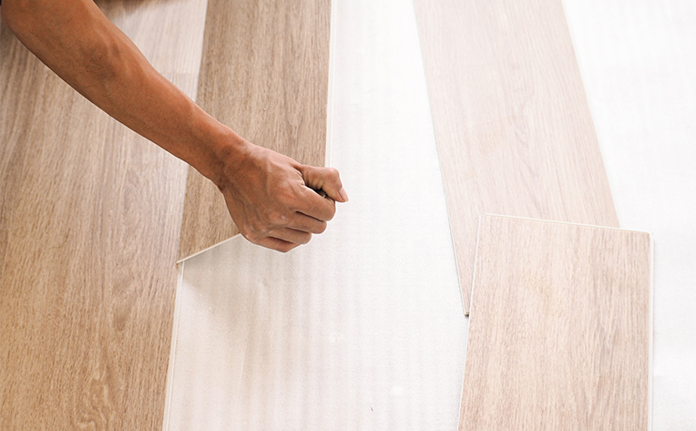 stock image of wood planks being installed using click-lock method