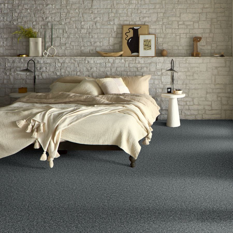 grey carpets in a bedroom with stone accent wall